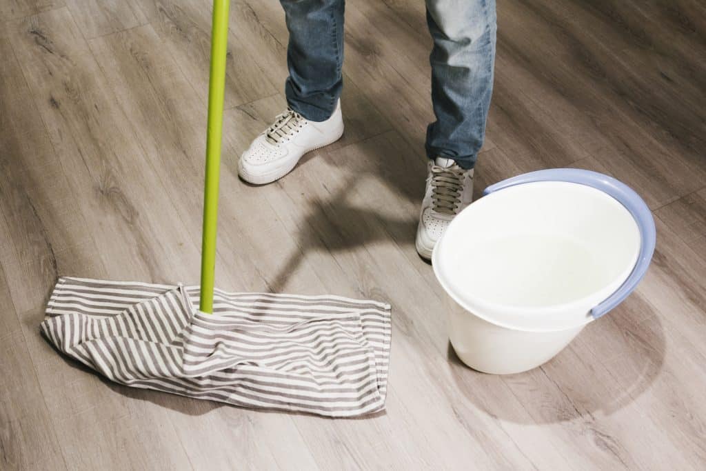 Hombre fregando suelo de madera